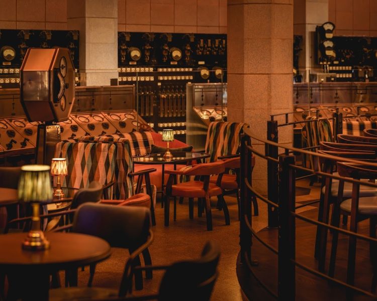 the bar area with tables at control room b at battersea power station