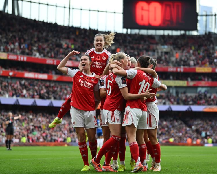 arsenal womens players celebrating a goal during a match