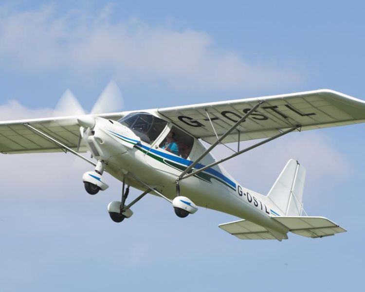 microlight in the sky flying from goodwood aerodrome