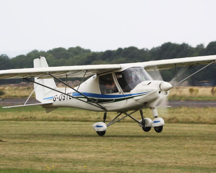 microlight taking off from goodwood aerodrome