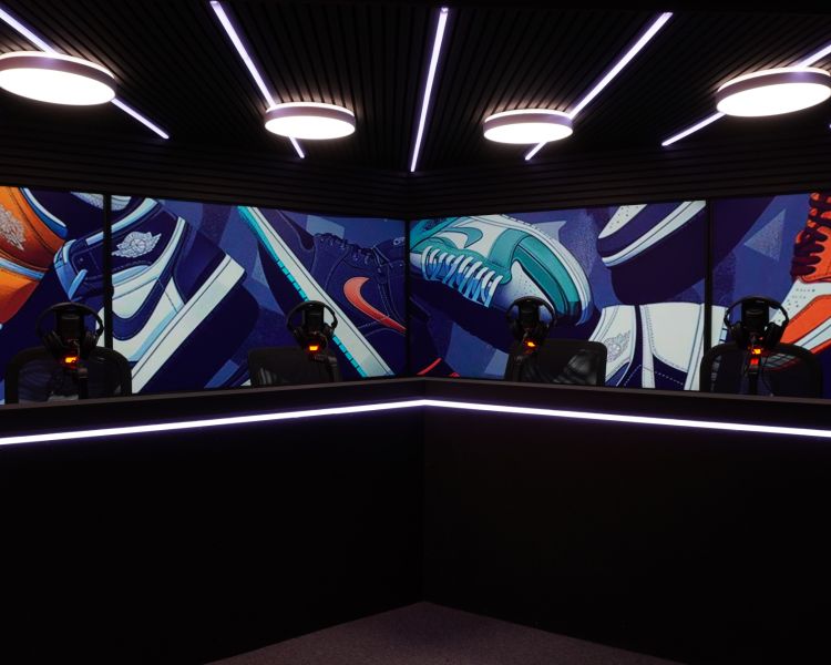 a podcast studio with tv wall behind the seating and desks
