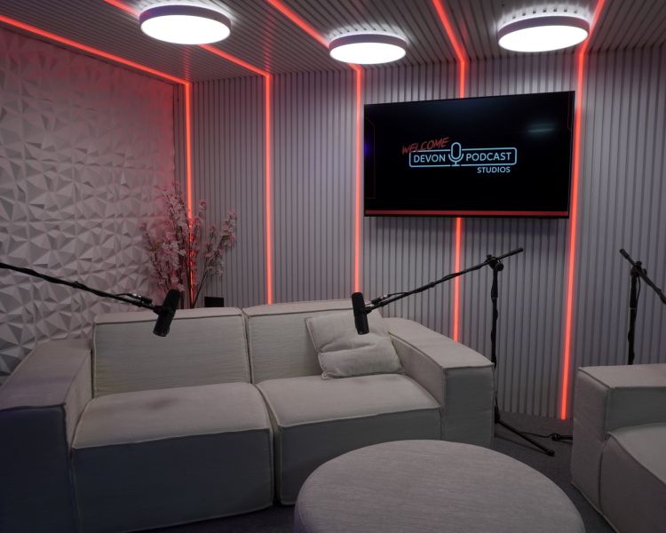 comfy chairs in a podcast studio with white walls