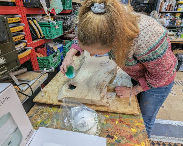 woman pouring resin on a resin art workshop in somerset