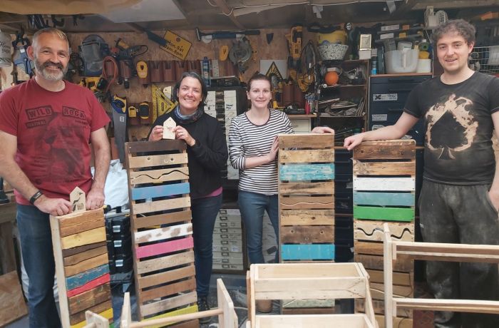 group with their items made on a pallet upcycle day course in somerset