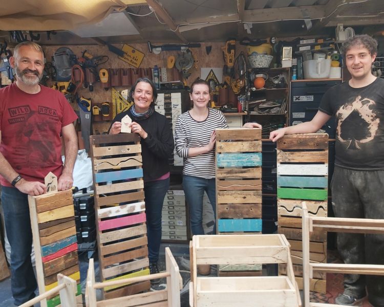 group with their items made on a pallet upcycle day course in somerset