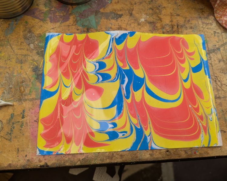 paper covered in pattern from water marbling technique