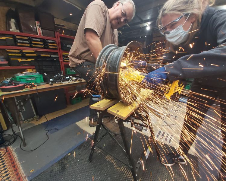 cutting metal in workshop to make a fire pit