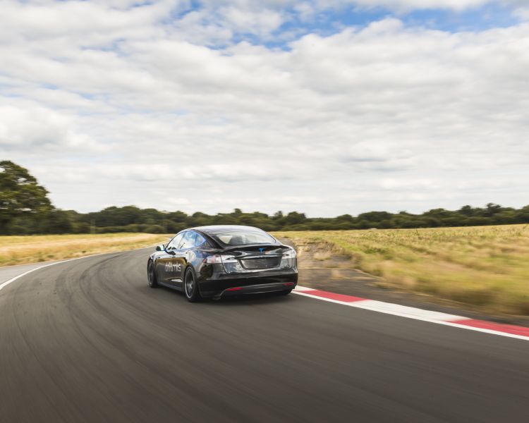 Rear view of black tesla model s p90d on track
