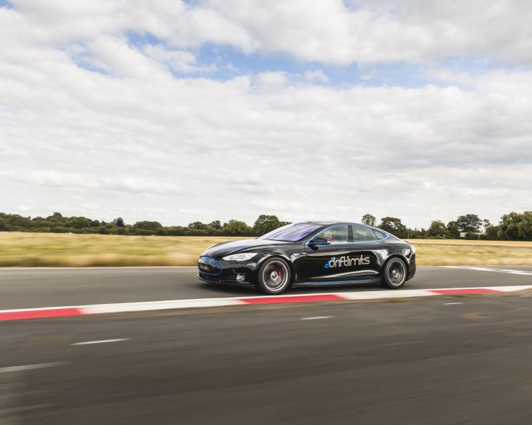 Side view of black tesla model s p90d on track