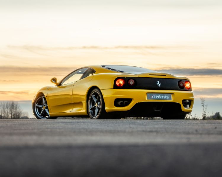 Rear view of yellow ferrari 360 moderna on track