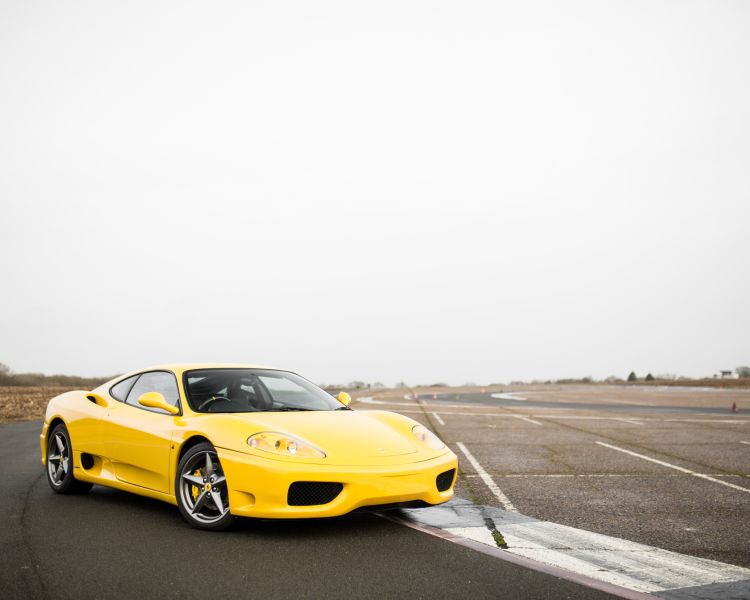 Yellow ferrari 360 moderna on a race track
