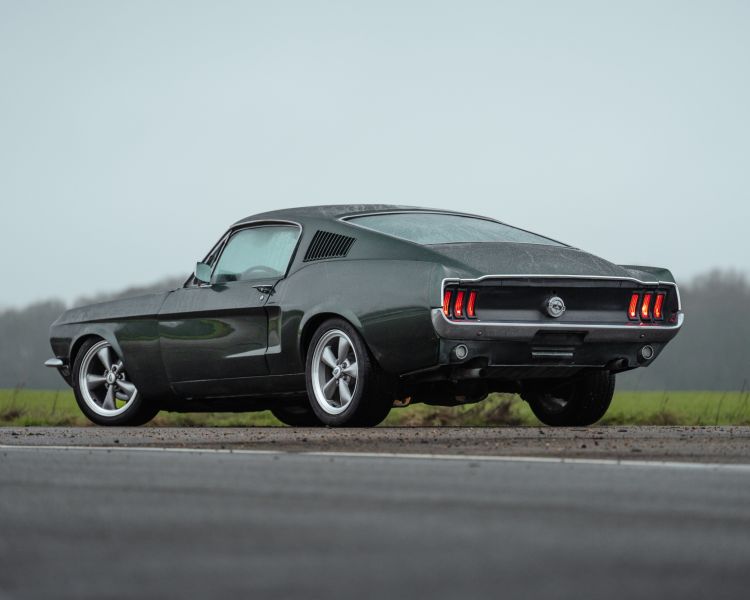 Rear view of black ford mustang bullitt on track