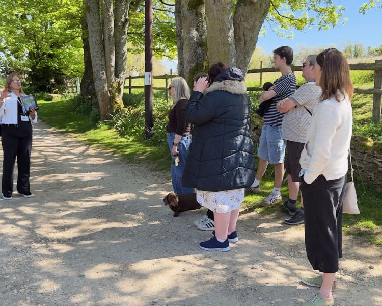 Group listening to guide on father brown location tour
