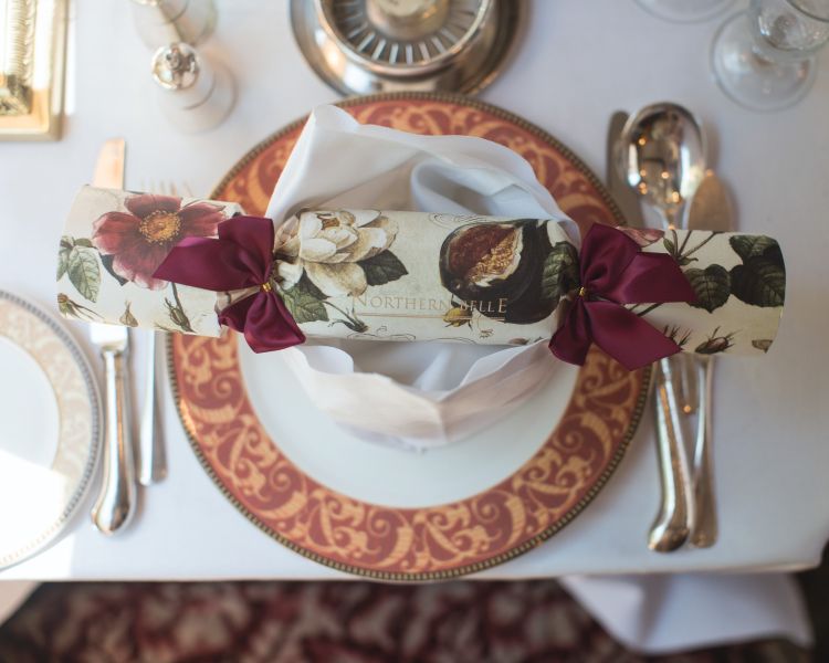 A northern belle christmas cracker on plate on table