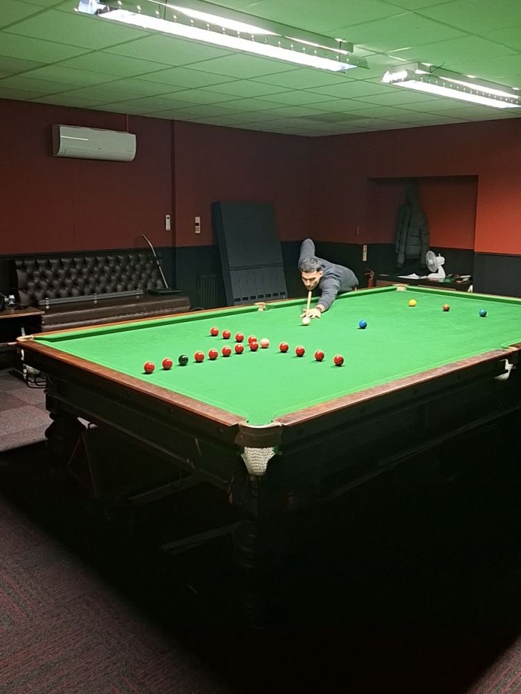 man at snooker table showing shot for snooker pool masterclass in london