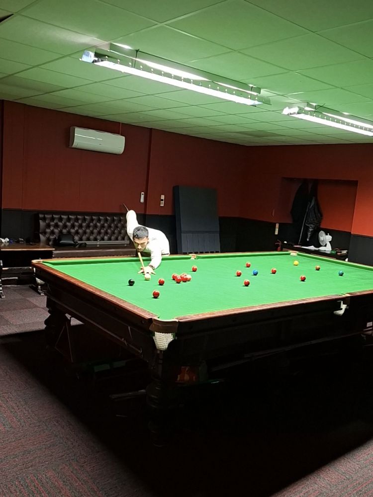 man demonstrating shot on pool table on a snooker pool private masterclass session