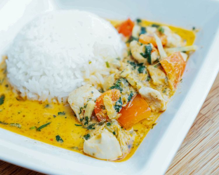 an indian dish with rice on a plate cooked during a half day indian cookery course experience day