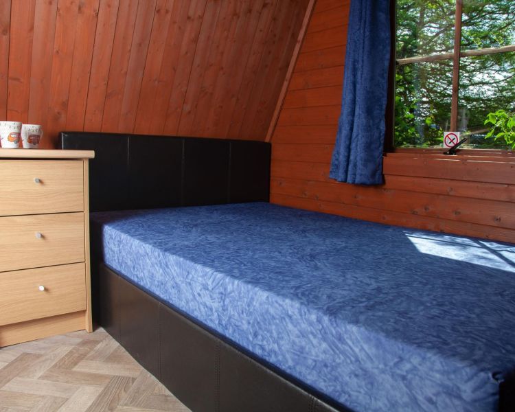 Bed inside glamping pod