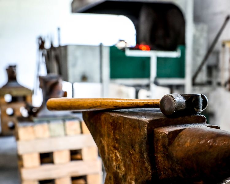 hammer on an anvil in a blacksmith forge