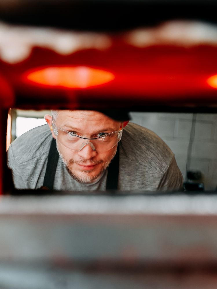 man looking into a forge while on a silversmithing day course