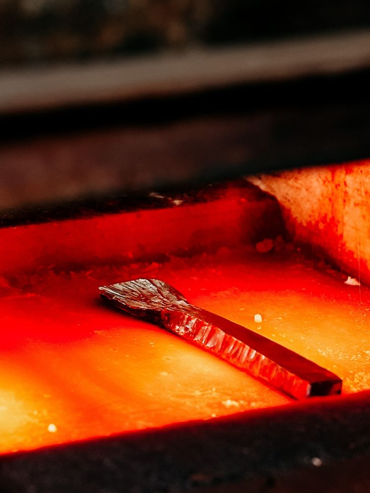 copper spoon being heated on a silversmithing day course