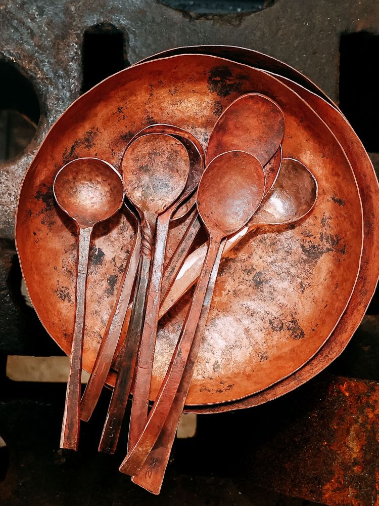 a copper bowl with copper spoons made on a silversmith day course