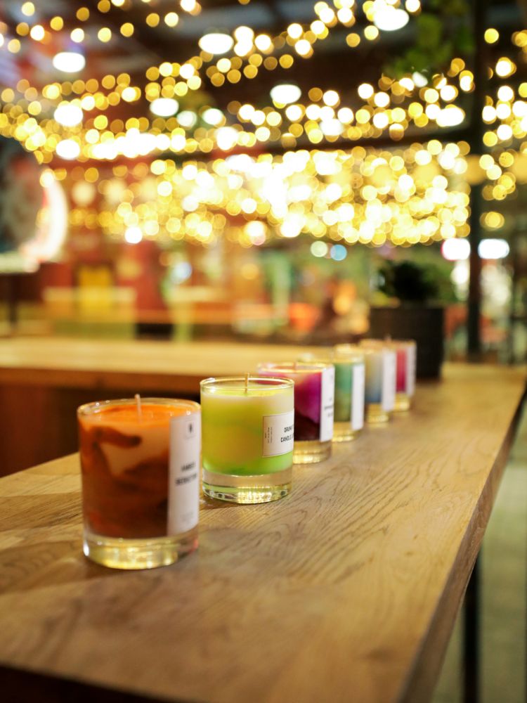 Row of hand made candles on table