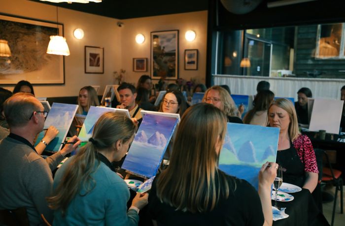 Paint and prosecco event with people painting and drinking prosecco