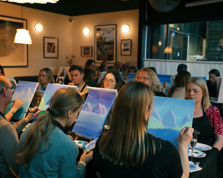 Paint and prosecco event with people painting and drinking prosecco