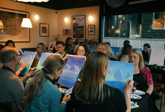 Paint and prosecco event with people painting and drinking prosecco