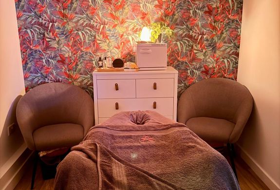 massage treatment room with massage bed for pamper session