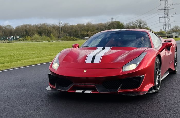A red ferrari 488 pista on a race track