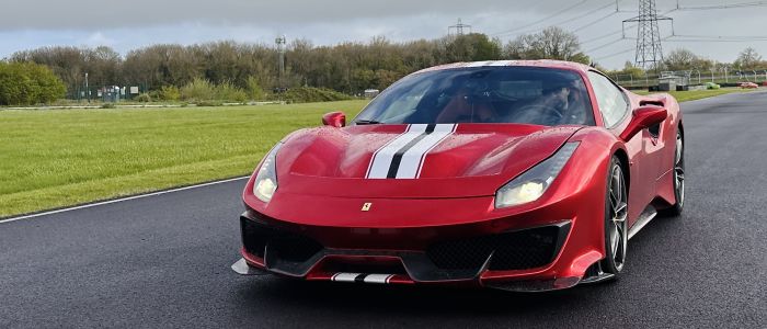 A red ferrari 488 pista on a race track