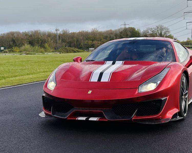 A red ferrari 488 pista on a race track