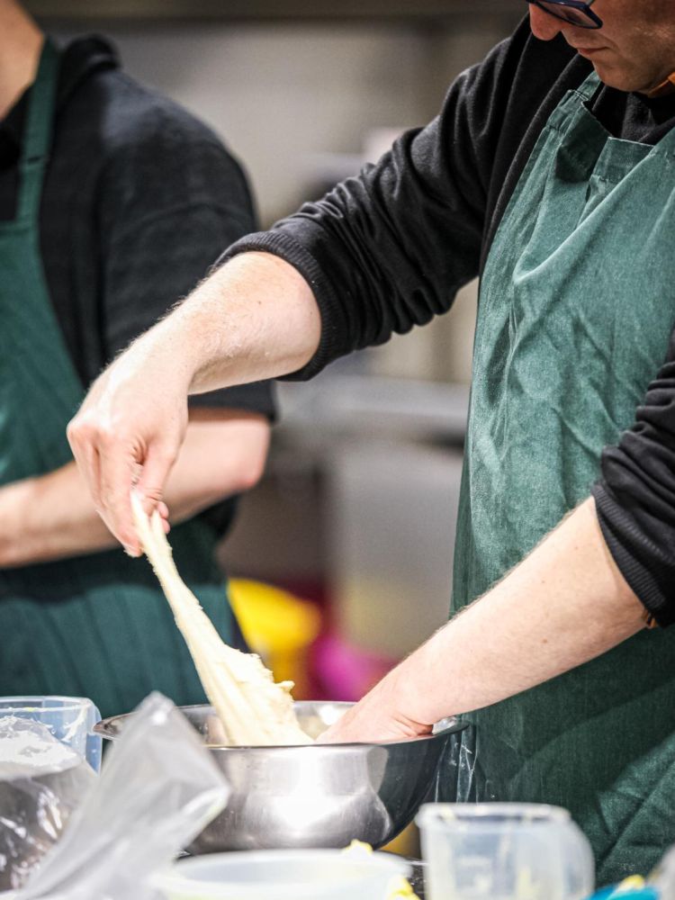 stretching dough on a continental bread making workshop