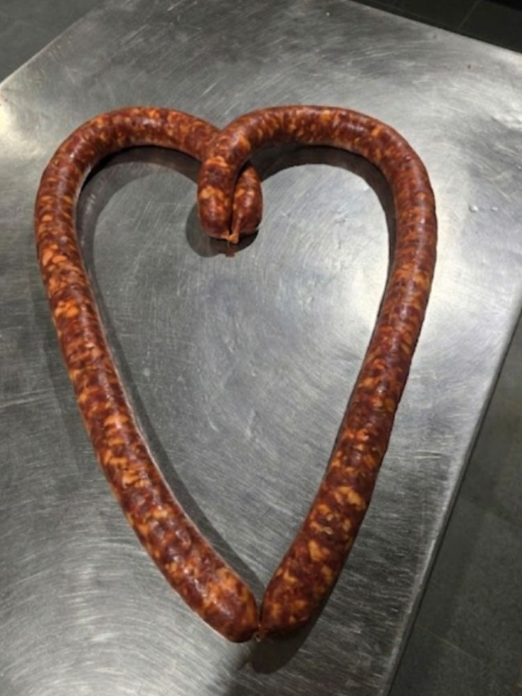 a heart shaped sausage handmade on a continental sausage making course
