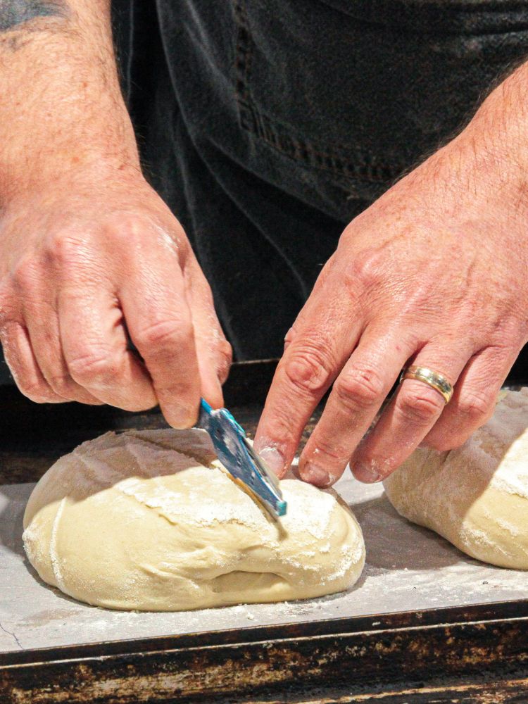 scoring surface of sourdough before baking