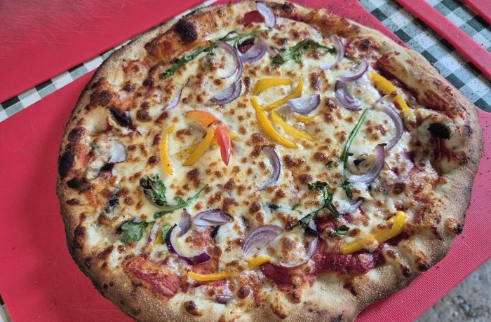 a wood-fired pizza made on a pizza making workshop