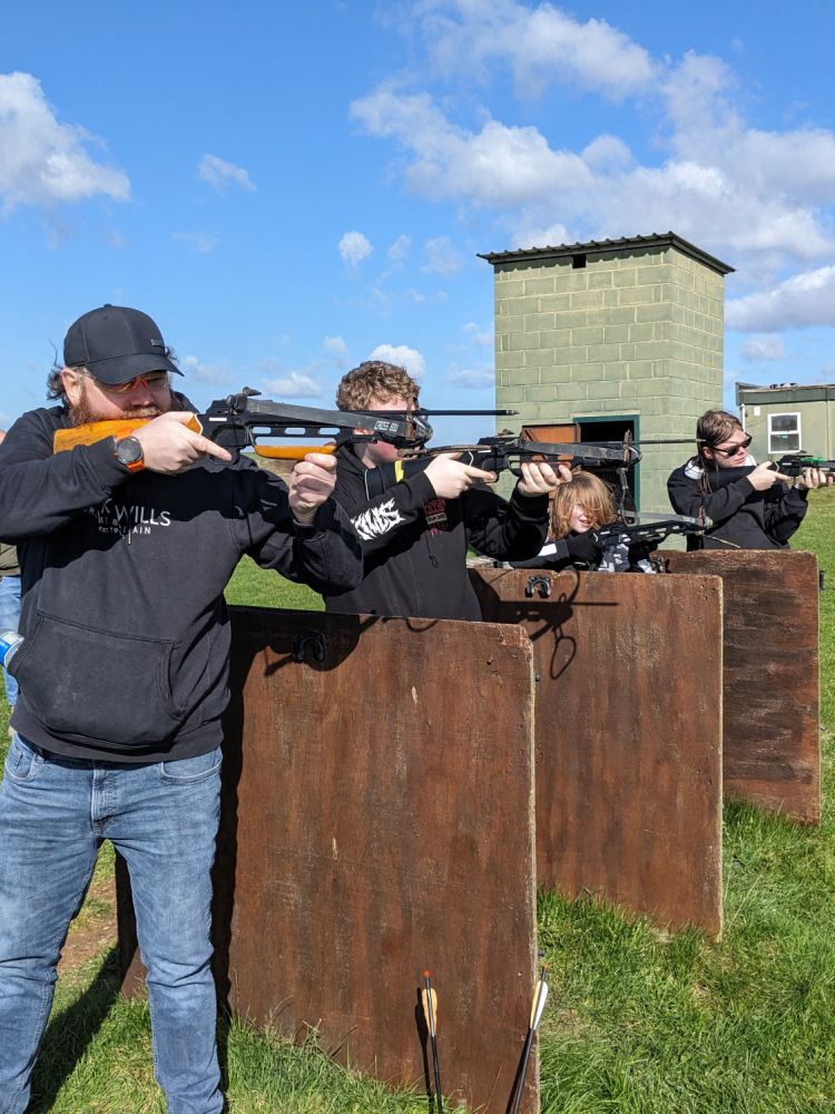 row of people on a shooting range on a zombie apocalypse weapons training experience