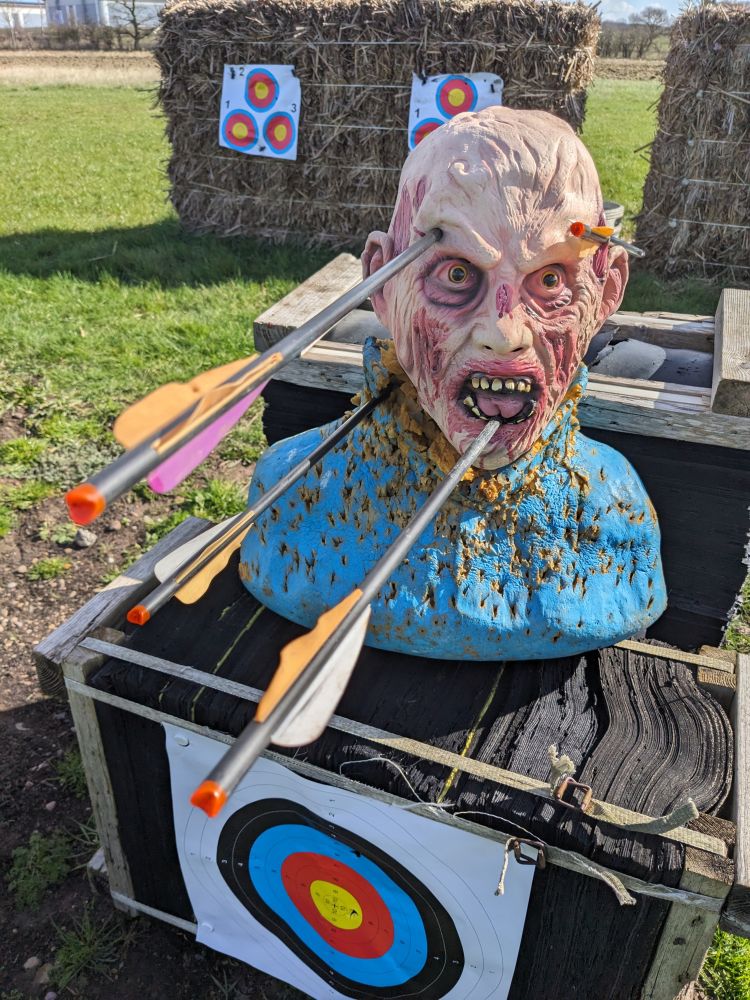 a zombie head arrow target used on a zombie apocalypse weapons training experience