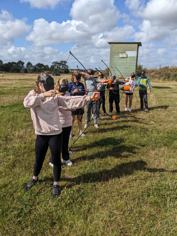 group shooting arrows on combat archery experience
