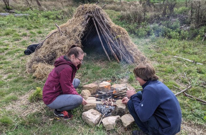 Couple next to campfire on a bushcraft experience