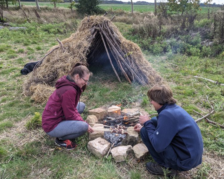 Couple next to campfire on a bushcraft experience