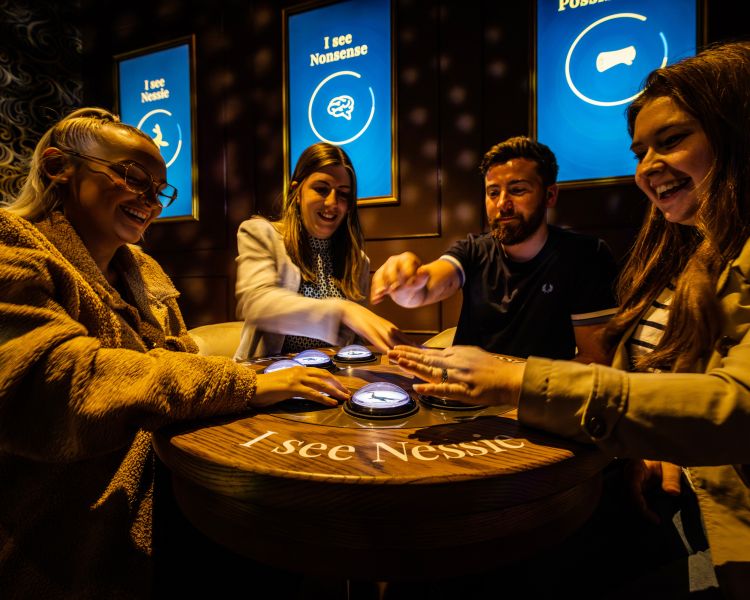 people at an interactive exhibit at the loch ness experience centre