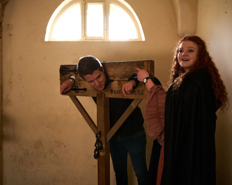 A guest is placed in a pillory at oxford castle and prison