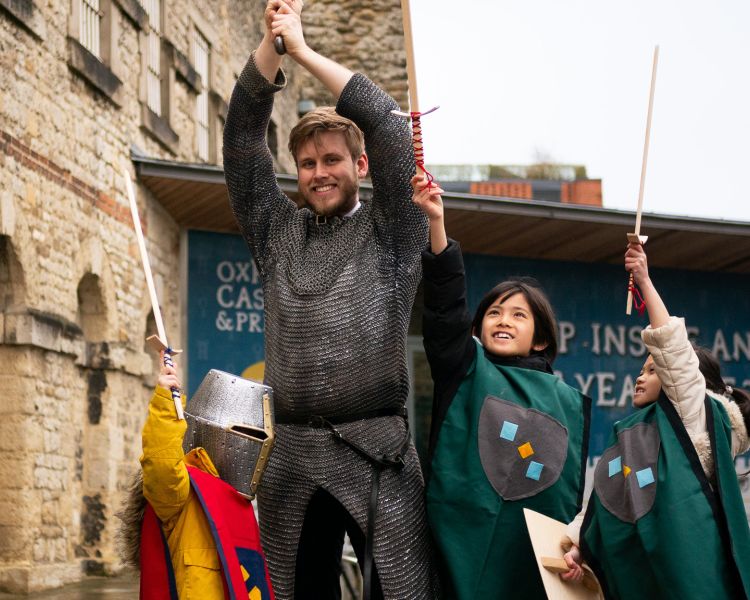 Children take part in Knight School in the Castle courtyard at oxford castle and prison