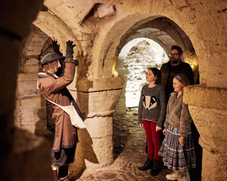 Guests on a guided tour in the crypt at oxford castle and prison