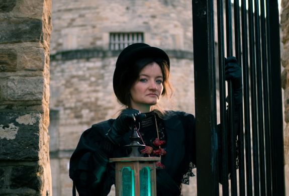 woman dressed in black as guide for spectre ghost tours at oxford castle and prison