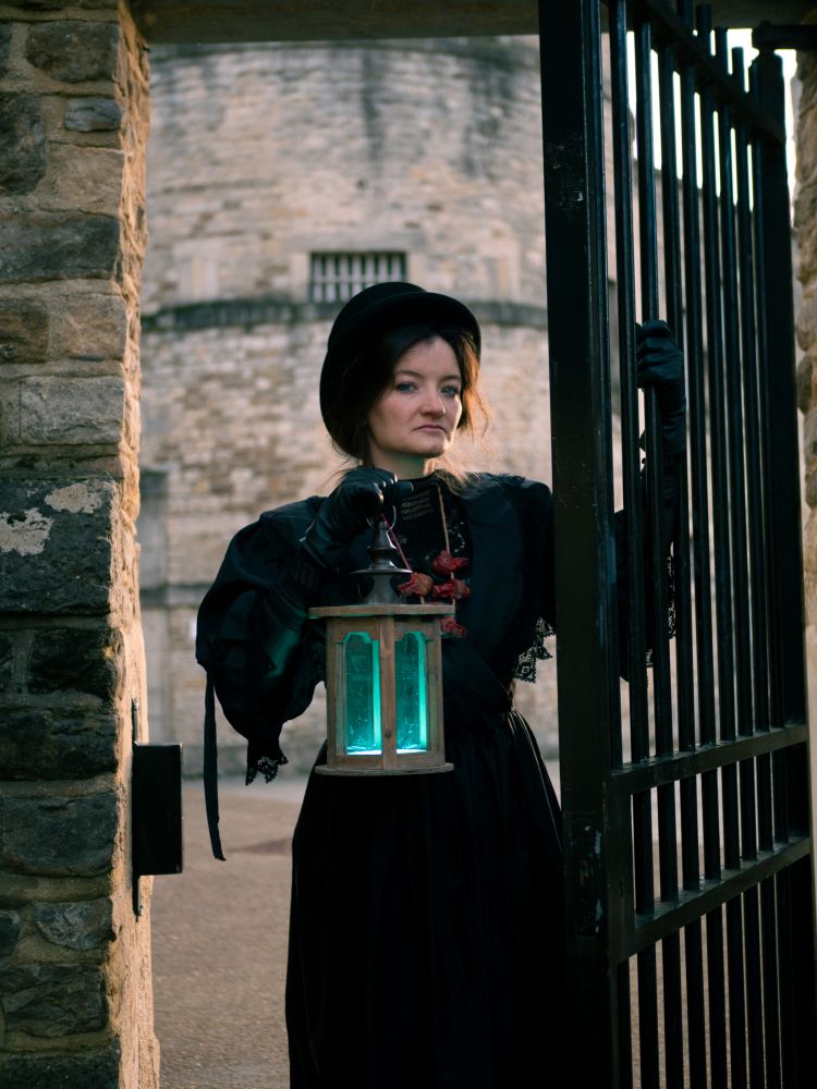 woman dressed in black as guide for spectre ghost tours at oxford castle and prison