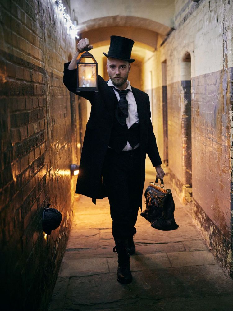 man dressed in black as guide for spectre ghost tours at oxford castle and prison